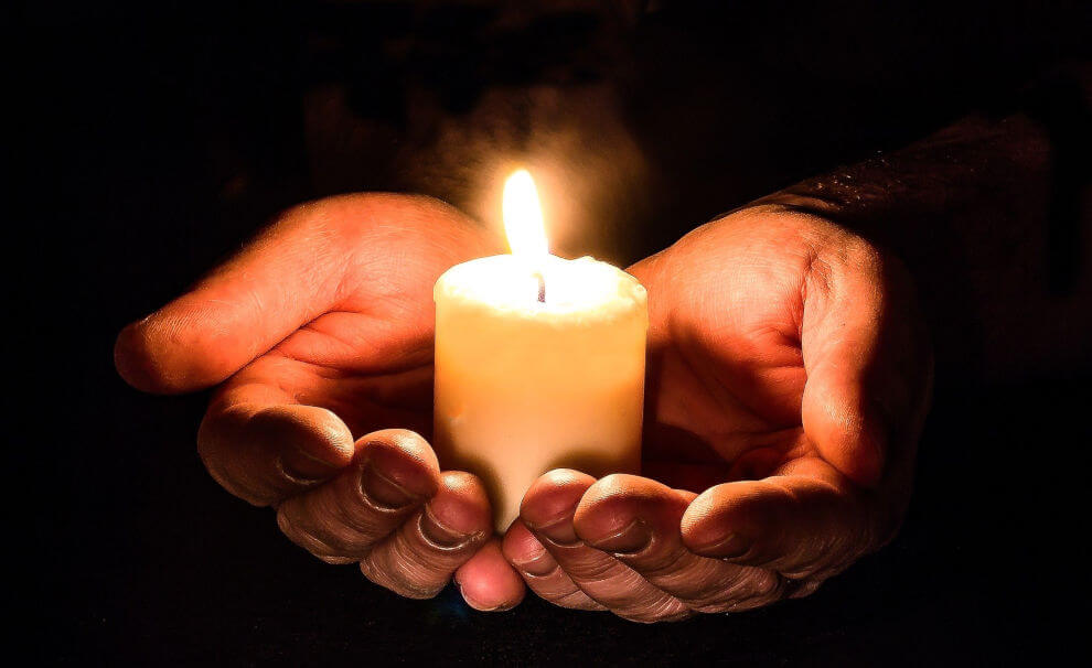 Hands with a candle